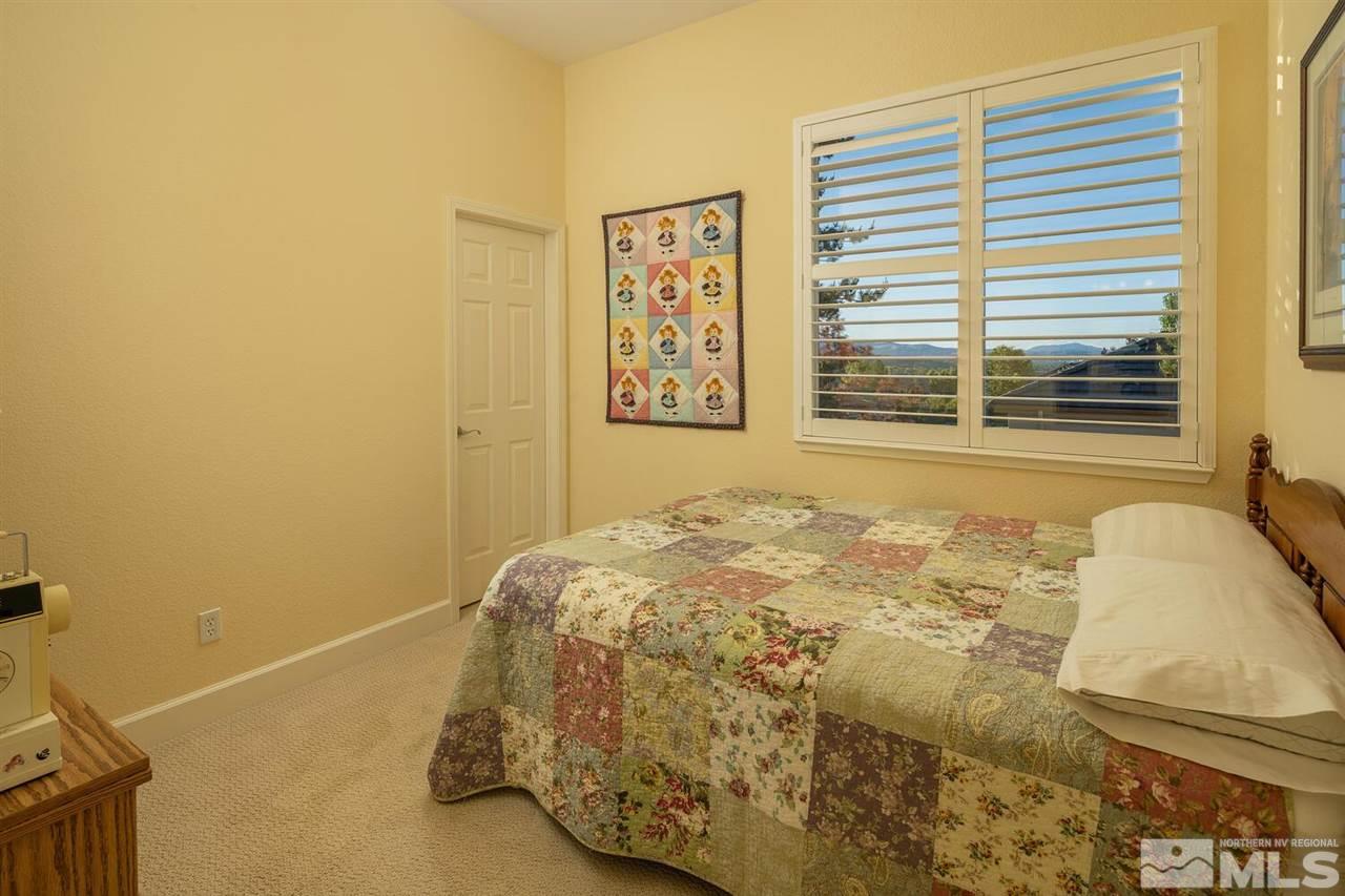 5633 North White Sands Road Reno, NV 89511 - Photo 20 of 40 a bedroom with a bed and a window
