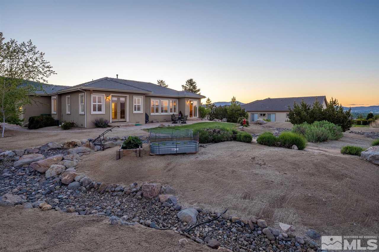5633 North White Sands Road Reno, NV 89511 - Photo 30 of 40 a view of a big house with a yard and large trees