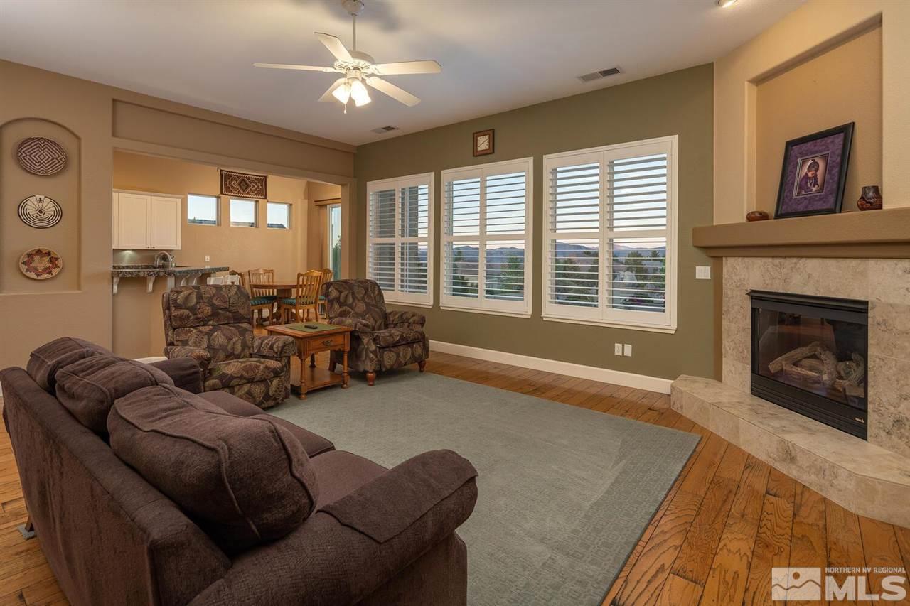 5633 North White Sands Road Reno, NV 89511 - Photo 8 of 40 a living room with furniture and a fireplace