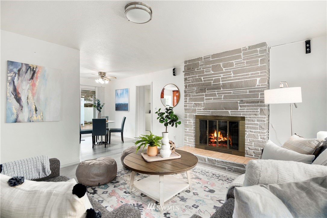 2905 Northeast 5th Place Renton, WA 98056 - Photo 8 of 36 a living room with furniture and a fireplace
