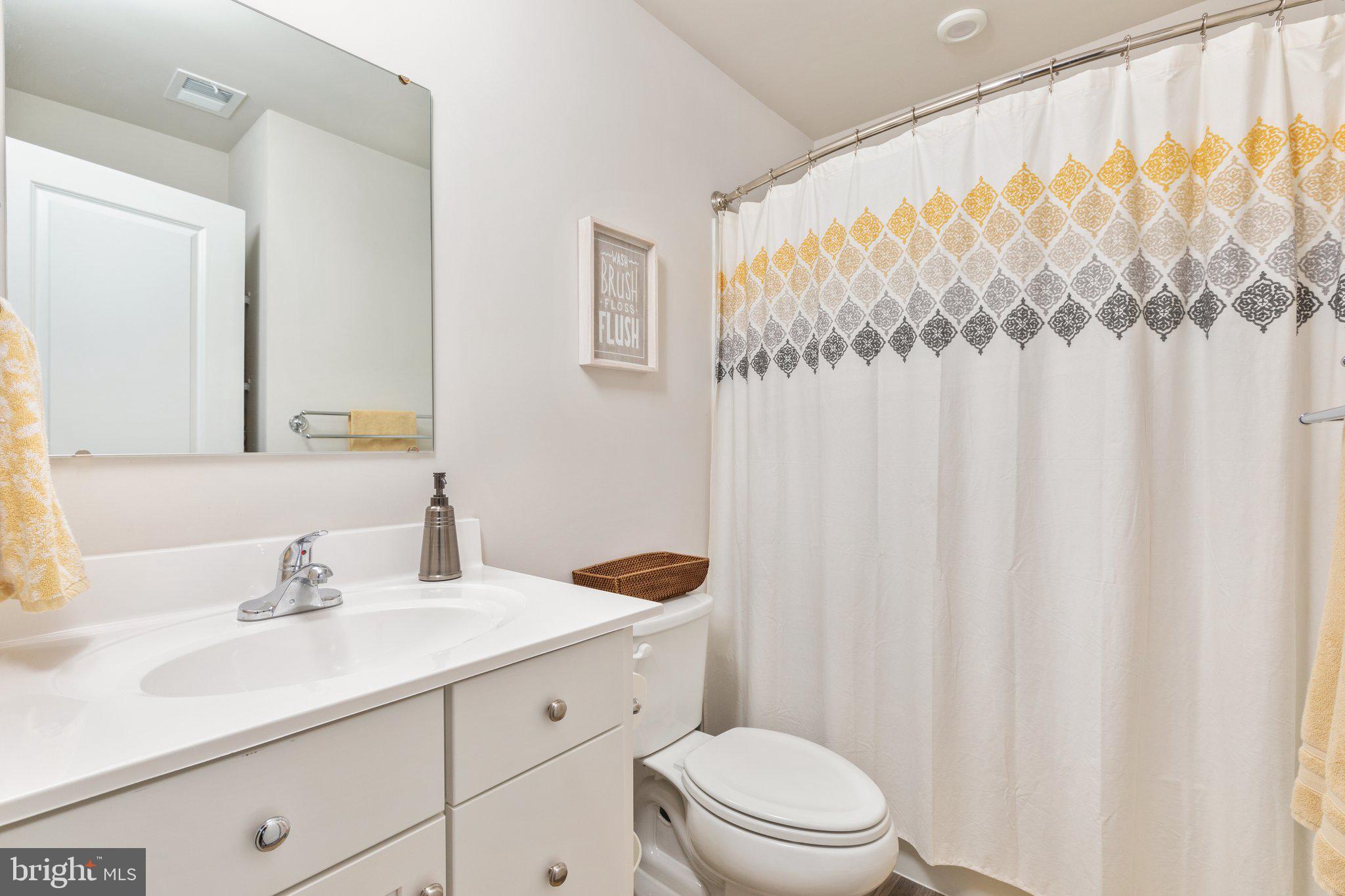 101 Williams Street Strasburg, VA 22657 - Photo 11 of 21 a bathroom with a granite countertop sink a toilet and a mirror