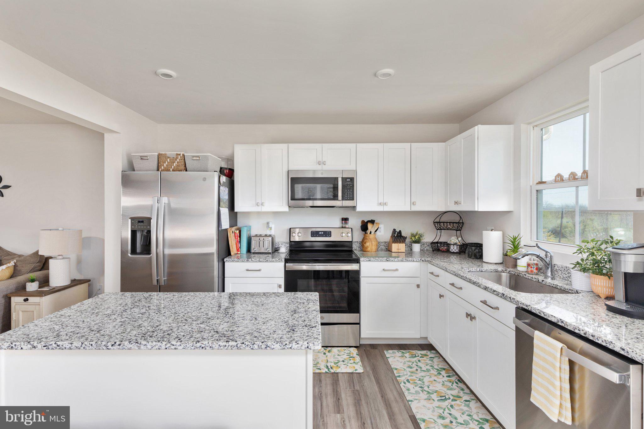 101 Williams Street Strasburg, VA 22657 - Photo 7 of 21 a kitchen with granite countertop a sink stove and refrigerator