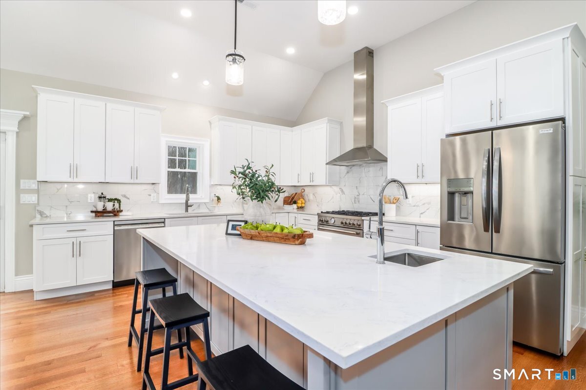 109 Codfish Hill Road Bethel, CT 06801 - Photo 3 of 43 a kitchen with stainless steel appliances a table chairs and a refrigerator