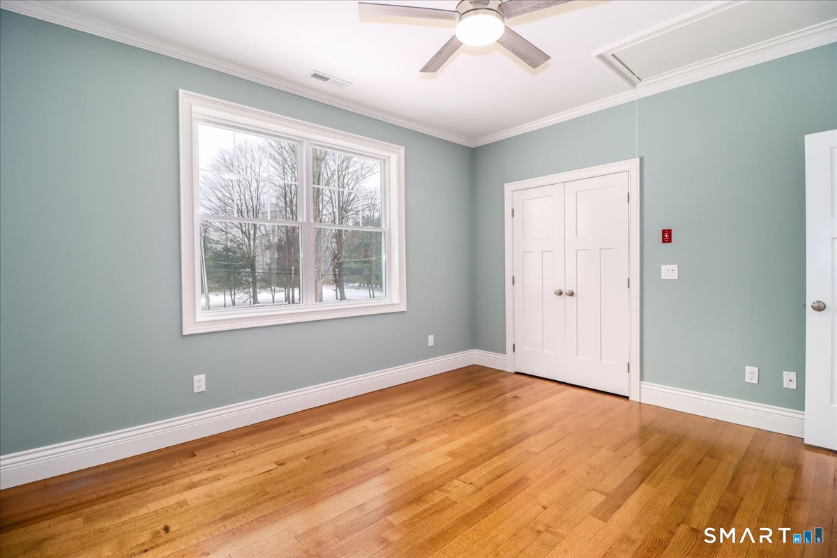 109 Codfish Hill Road Bethel, CT 06801 - Photo 36 of 43 a view of an empty room with wooden floor and a window