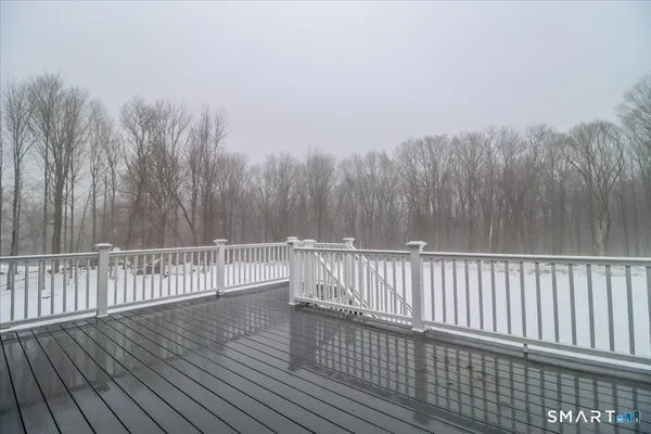 a view of a roof deck with wooden fence