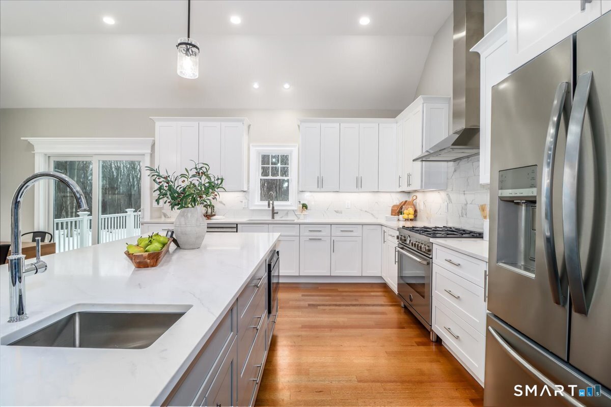 109 Codfish Hill Road Bethel, CT 06801 - Photo 5 of 43 a kitchen with refrigerator a sink and white cabinets