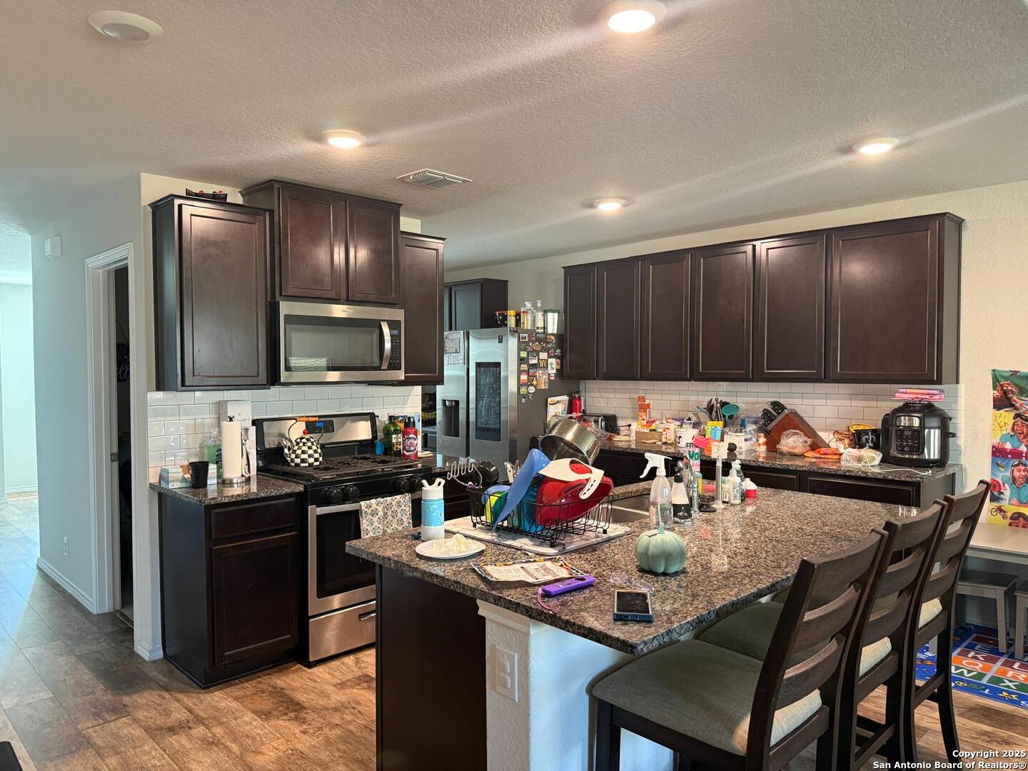 6411 Kendall Cove Converse, TX 78109 - Photo 6 of 9 a kitchen with a cabinets appliances and a dining table