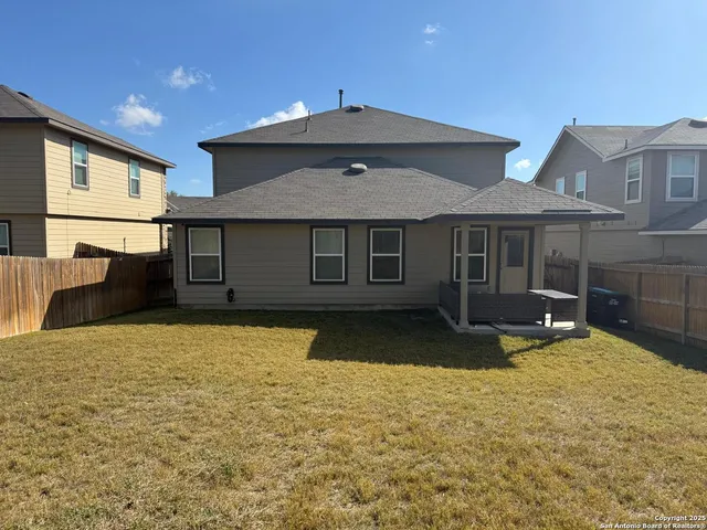 a front view of a house with yard and glass windows
