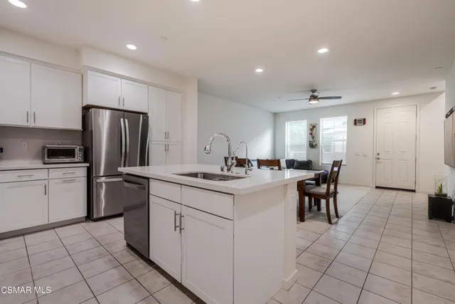 a kitchen with a sink appliances and cabinets
