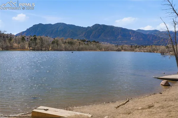 a view of a lake in middle of a forest
