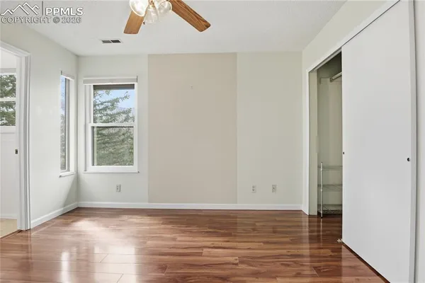 a view of room with window and wooden floor