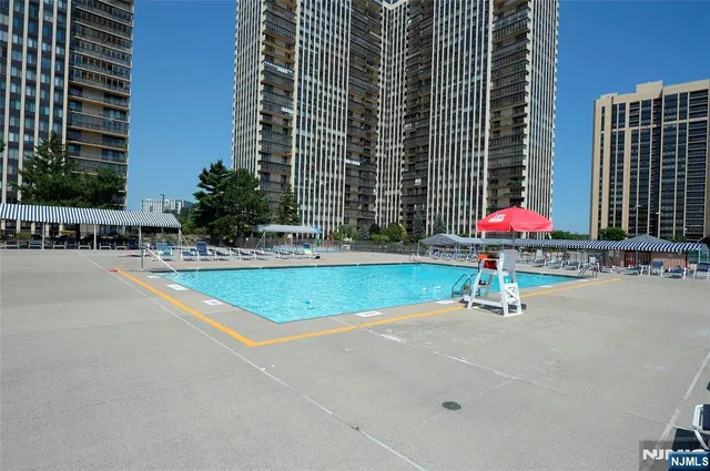 a view of a swimming pool with a lawn chairs