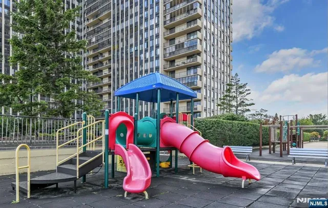 an outdoor sitting area with furniture and wooden fence
