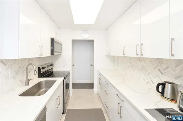 a kitchen with a sink and a stove top oven