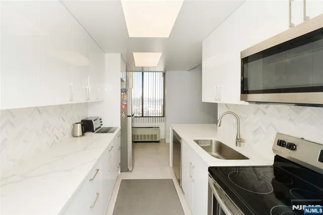 a kitchen with a sink a stove and a microwave