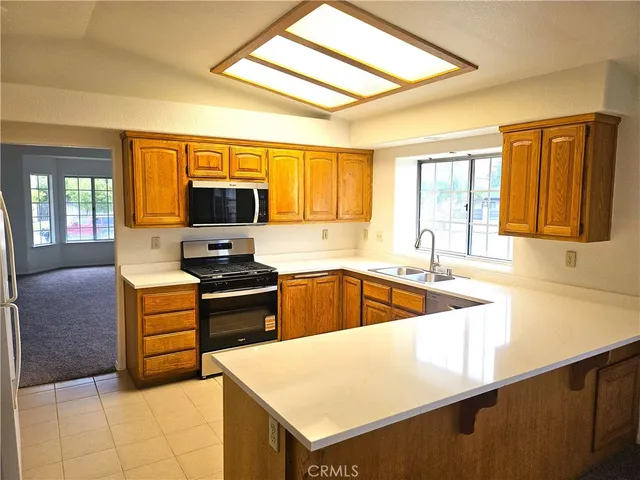 a kitchen with a sink a stove and cabinets