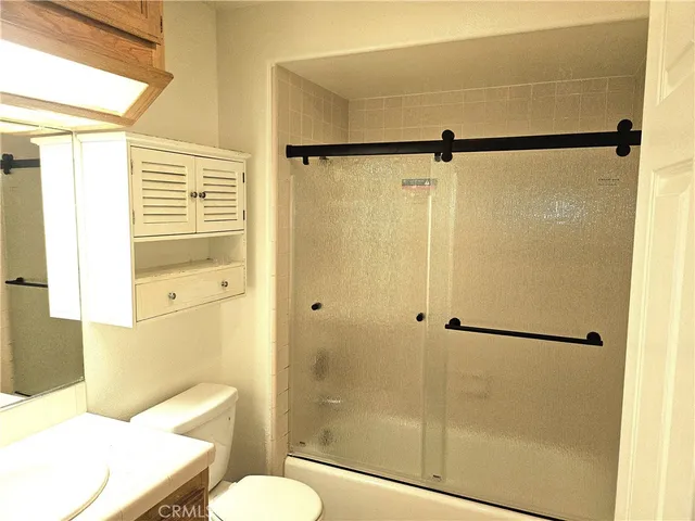 a bathroom with a shower a toilet and a sink