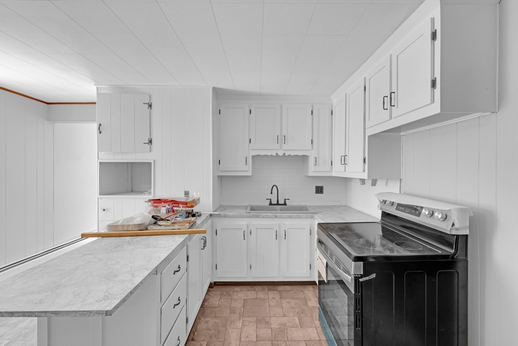 47 Morris Street Southbridge, MA 01550 - Photo 3 of 40 a kitchen with cabinets appliances a sink and a counter space