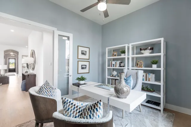 a living room with furniture and a book shelf