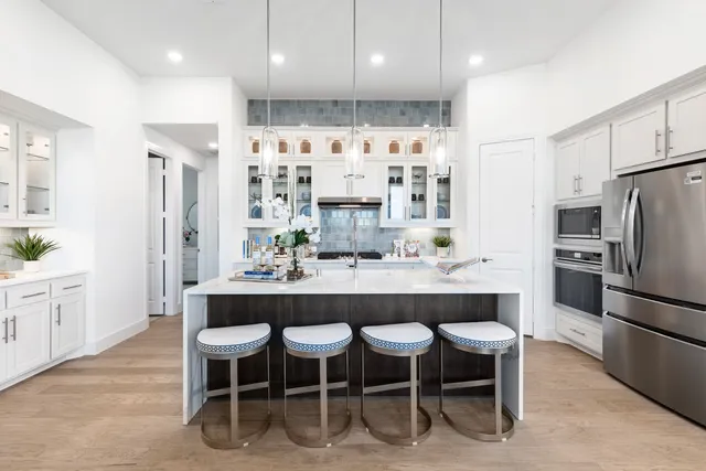 a large kitchen with a table and chairs
