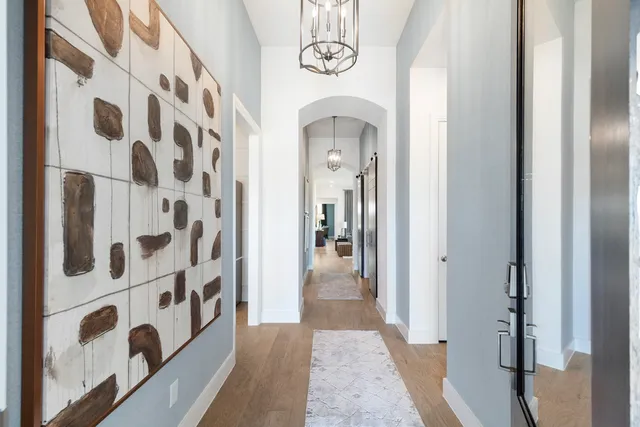 a view of a hallway with entryway wooden floor and front door