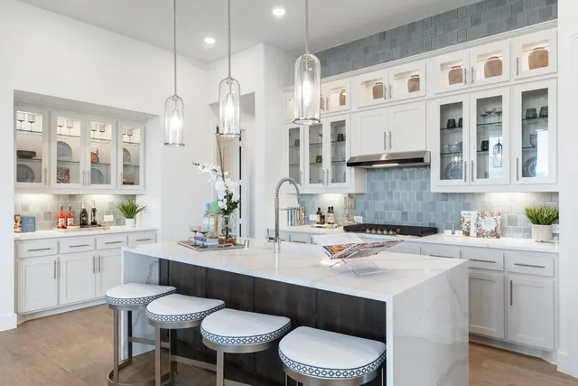 a kitchen with a sink cabinets and wooden floor