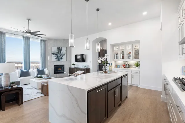 a kitchen with kitchen island a sink a center island a stove and a cabinets