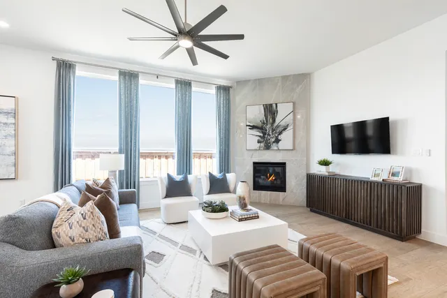 a living room with furniture a fireplace and a flat screen tv