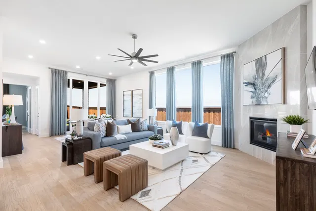 a living room with furniture a large window and a fireplace