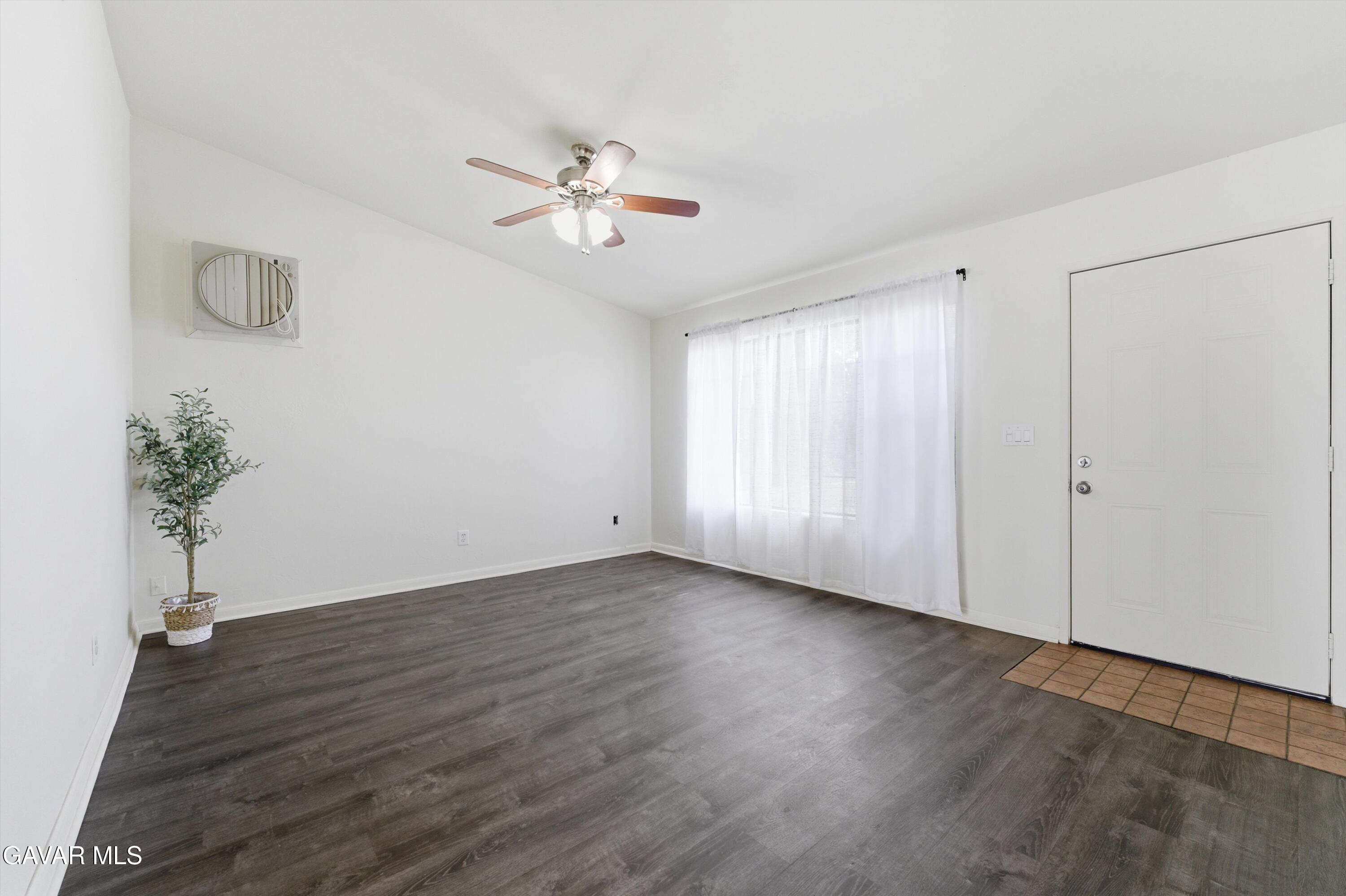 21410 Mission Street Tehachapi, CA 93561 - Photo 3 of 19 a view of an empty room with wooden floor and a window