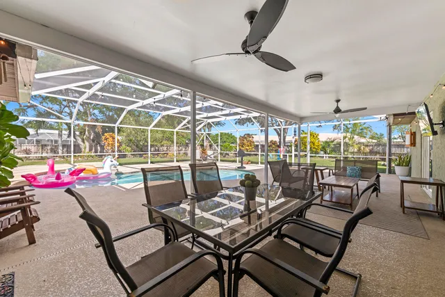 a bedroom with a bed a ceiling fan and a wooden floor
