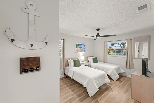 a bedroom with a bed and a tv on table