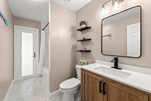 a bedroom with two beds and a chandelier