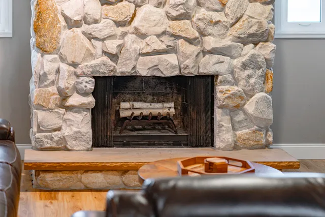 a living room with furniture a fireplace and a flat screen tv