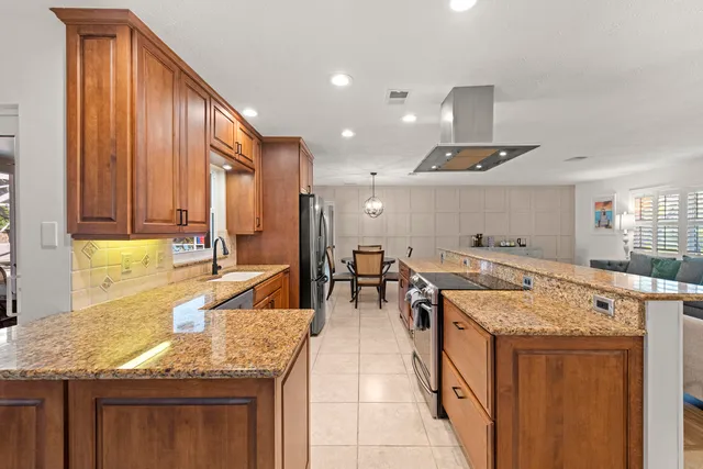 a kitchen with center island and stainless steel appliances