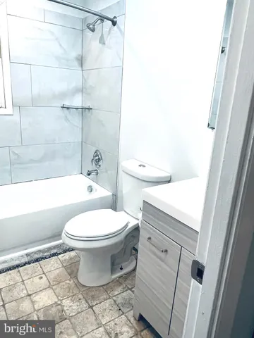a bathroom with a toilet a sink and bathtub
