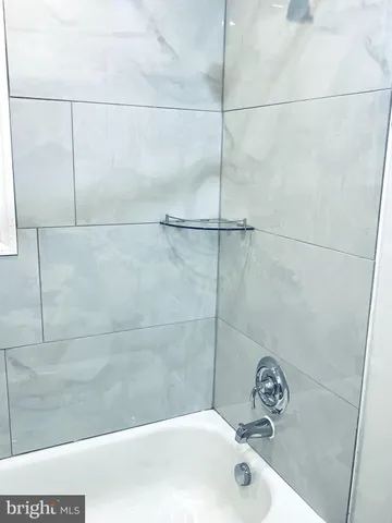a bathroom with a tub and a shower