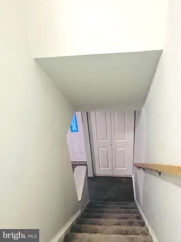 a room with a bench and hardwood floor