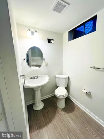 a bathroom with a sink toilet and mirror