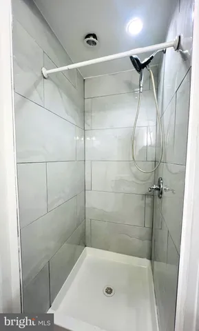 a bathroom with a shower and a glass door
