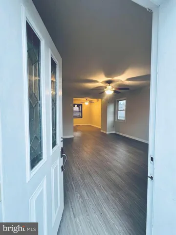 a view of livingroom with hardwood floor and a ceiling fan