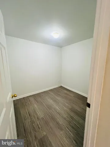 an empty room with wooden floor