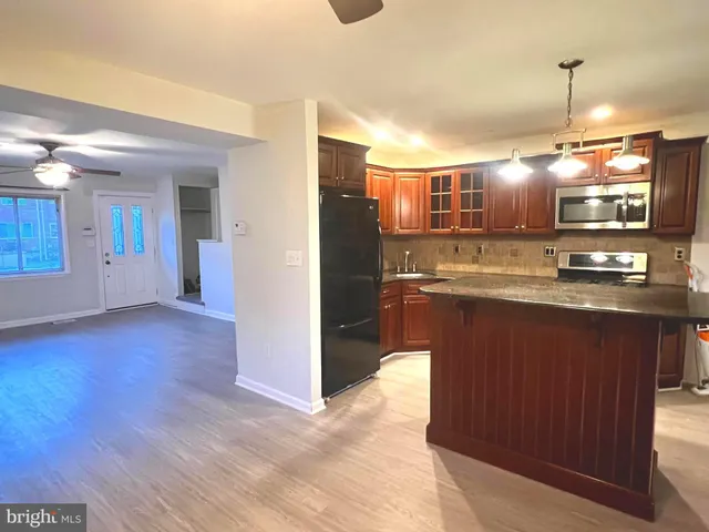 a kitchen with stainless steel appliances granite countertop a sink and cabinets