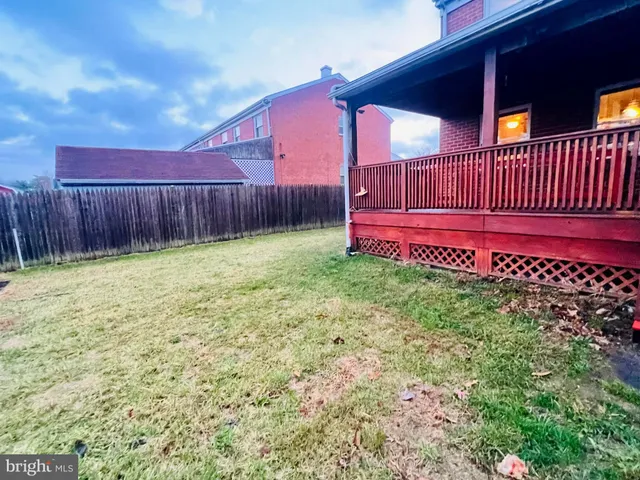 a view of a backyard with wooden fence