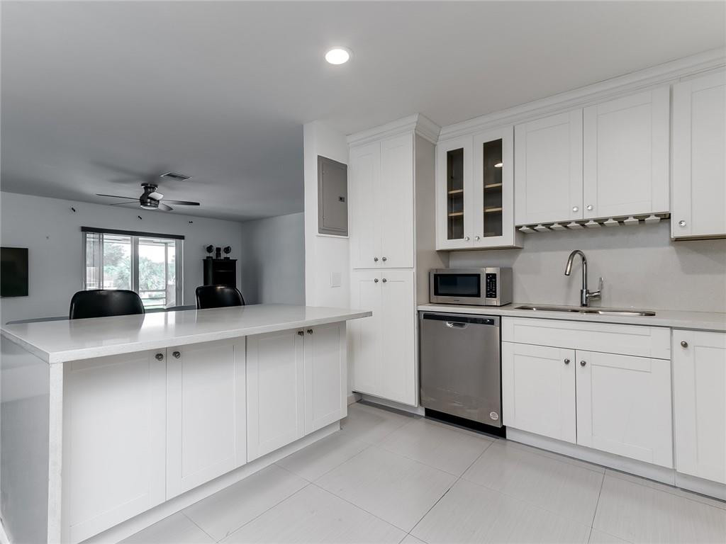 22735 Southwest 66th Avenue, Unit 202 Boca Raton, FL 33428 - Photo 1 of 30 a kitchen with cabinets and stainless steel appliances