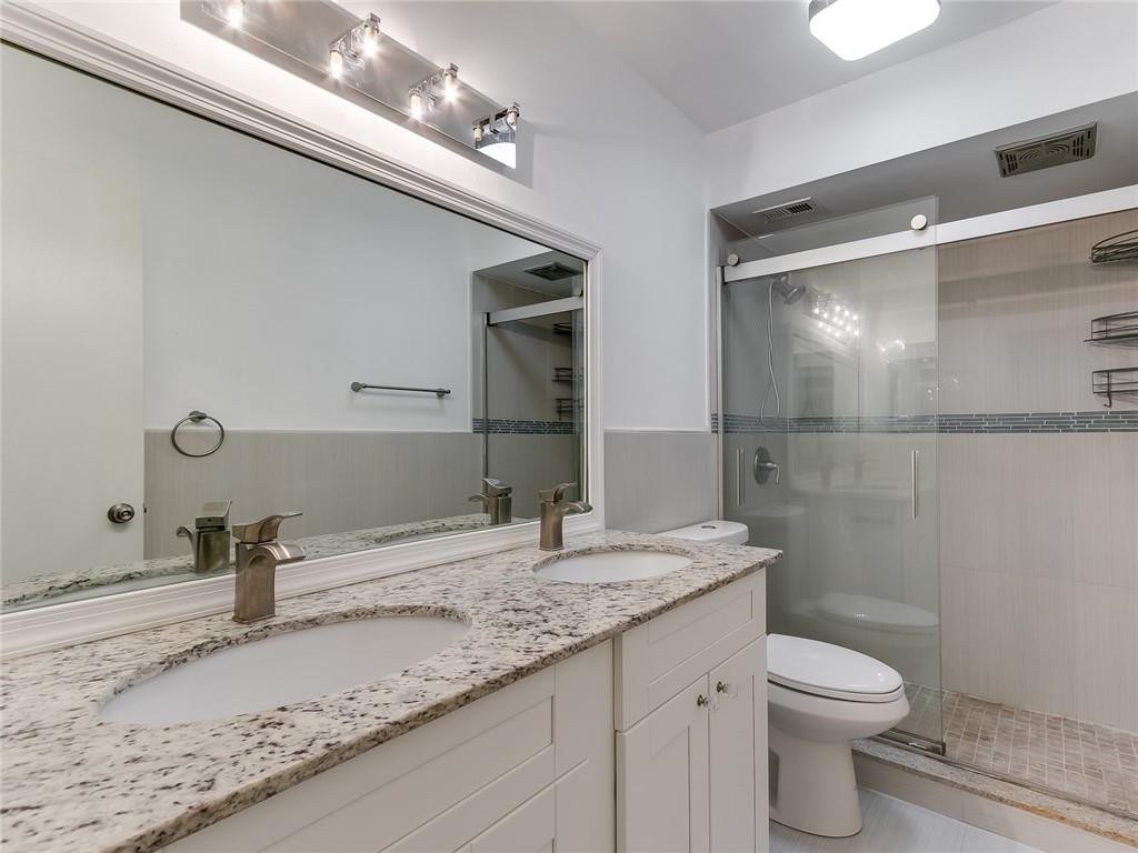 22735 Southwest 66th Avenue, Unit 202 Boca Raton, FL 33428 - Photo 16 of 30 a bathroom with a granite countertop sink toilet and shower