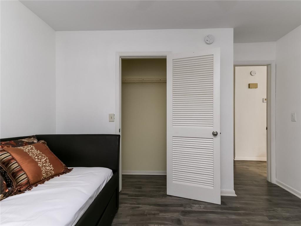 22735 Southwest 66th Avenue, Unit 202 Boca Raton, FL 33428 - Photo 18 of 30 a bedroom with a bed and a night stand