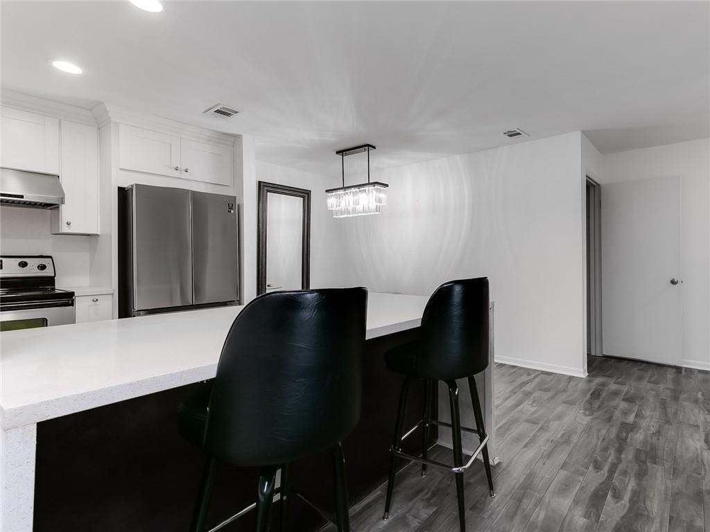 22735 Southwest 66th Avenue, Unit 202 Boca Raton, FL 33428 - Photo 2 of 30 a living room with furniture and a refrigerator