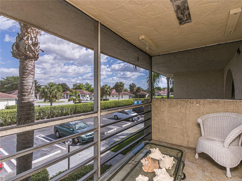 22735 Southwest 66th Avenue, Unit 202 Boca Raton, FL 33428 - Photo 23 of 30 a view of a living room and a floor to ceiling window