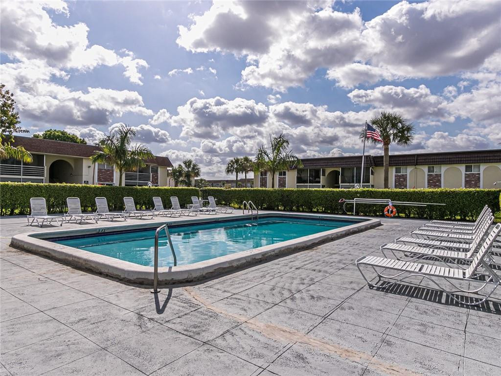 22735 Southwest 66th Avenue, Unit 202 Boca Raton, FL 33428 - Photo 25 of 30 a view of a terrace with wooden benches